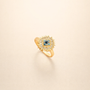 Gold twist ring with sapphire and sunburst design