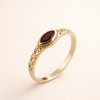 Elegant gold ring with a red cubic zirconia