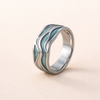 Silver ring with wave design and turquoise accents