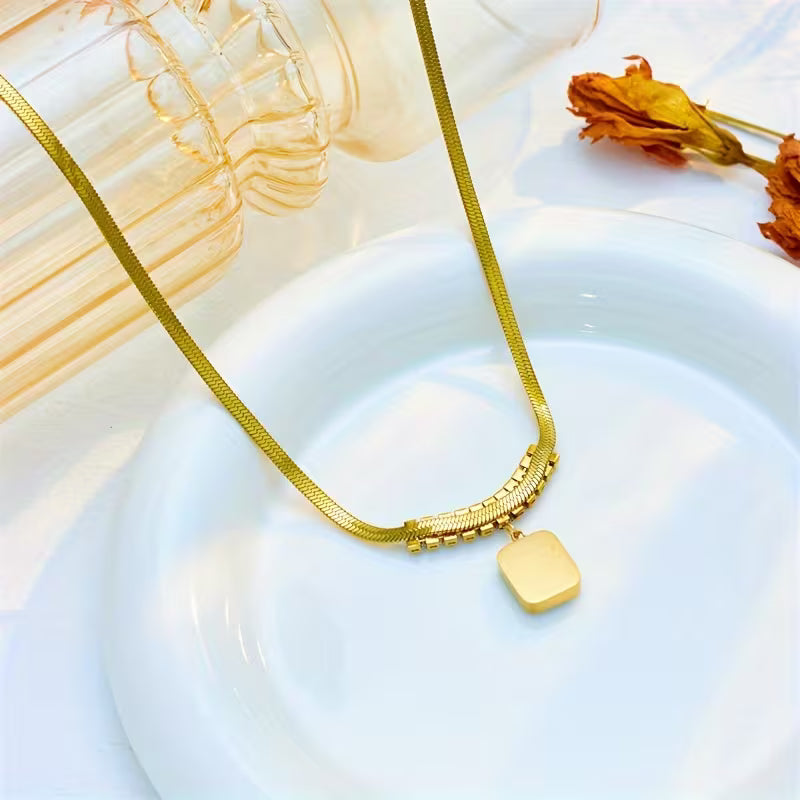 Elegant Gold Pendant with Emerald Prism