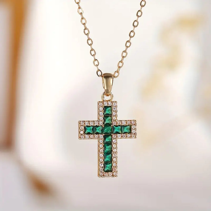 Elegant gold necklace with emerald cross pendant