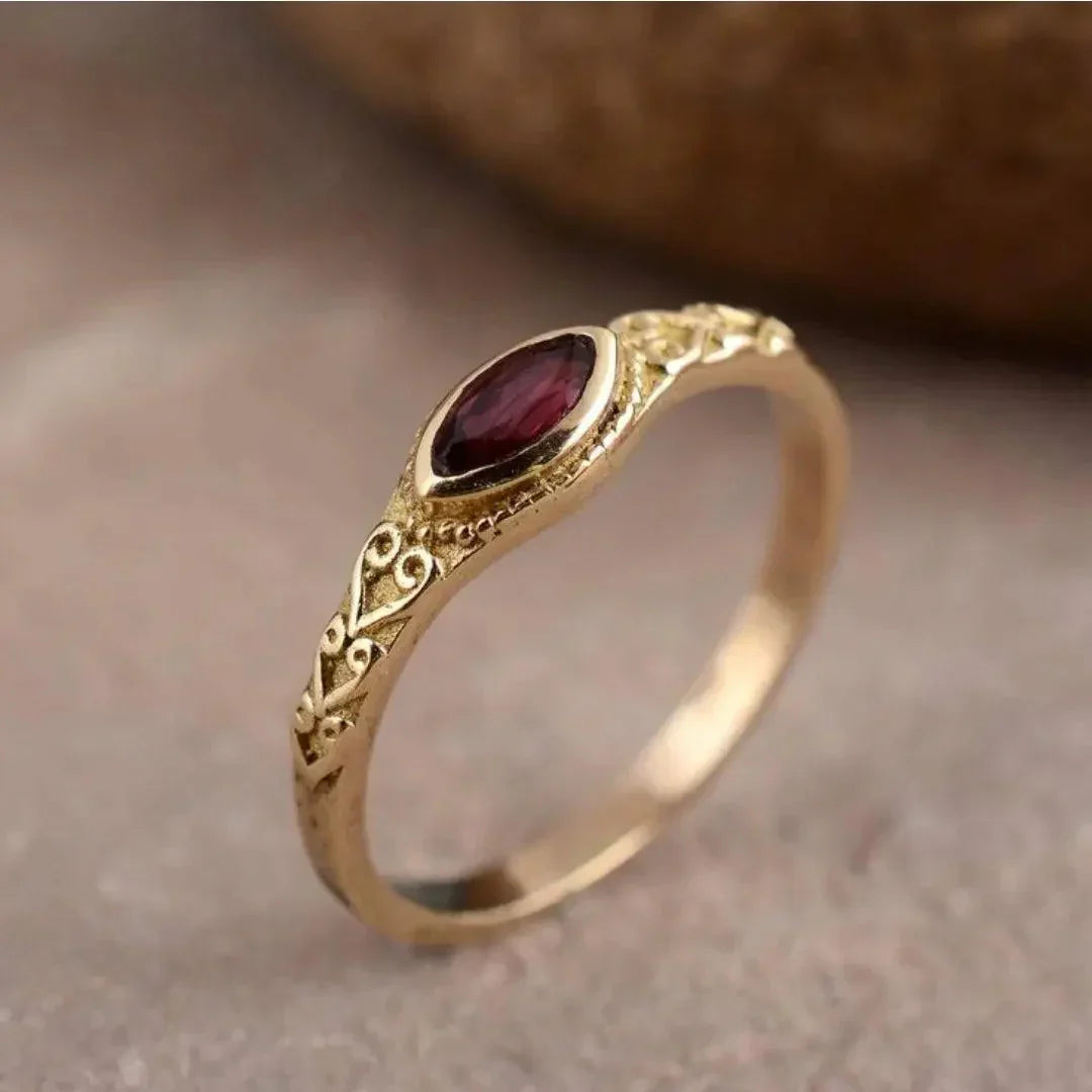 Elegant gold ring with a red cubic zirconia