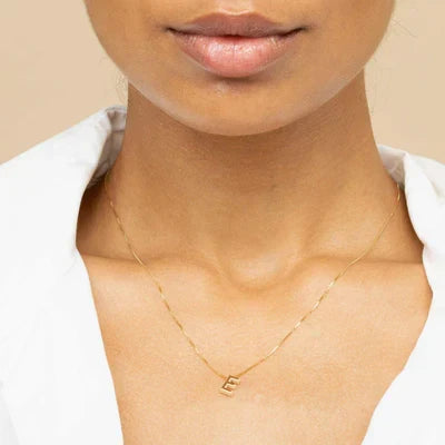 Refined white gold necklace with initial pendant.