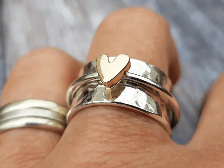 Silver ring with little gold heart