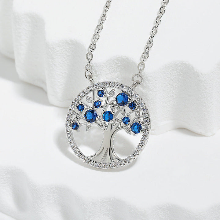 Elegant white gold pendant with sapphire and tree of life