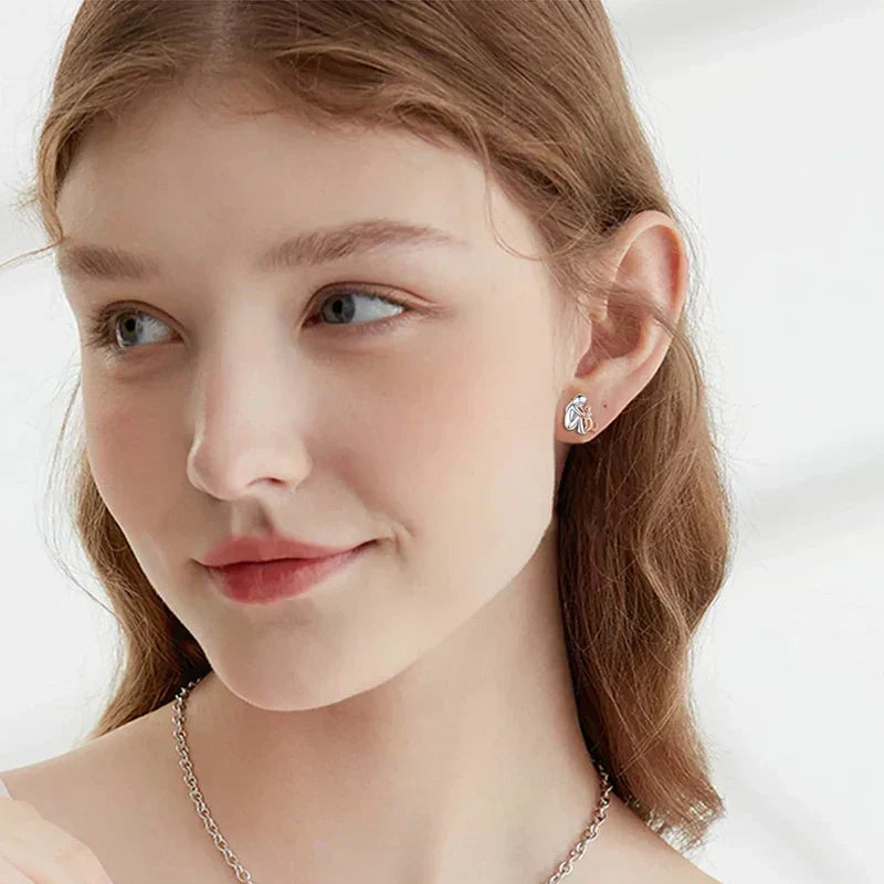 Soft gold earrings with a delicate flower