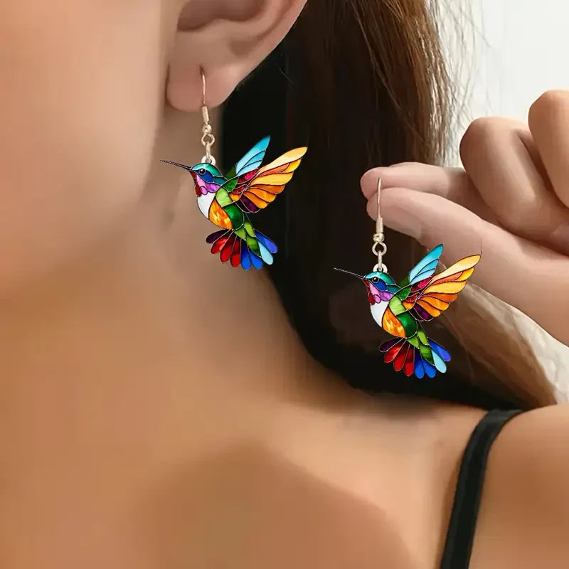 Elegant white gold earrings with colorful hummingbird