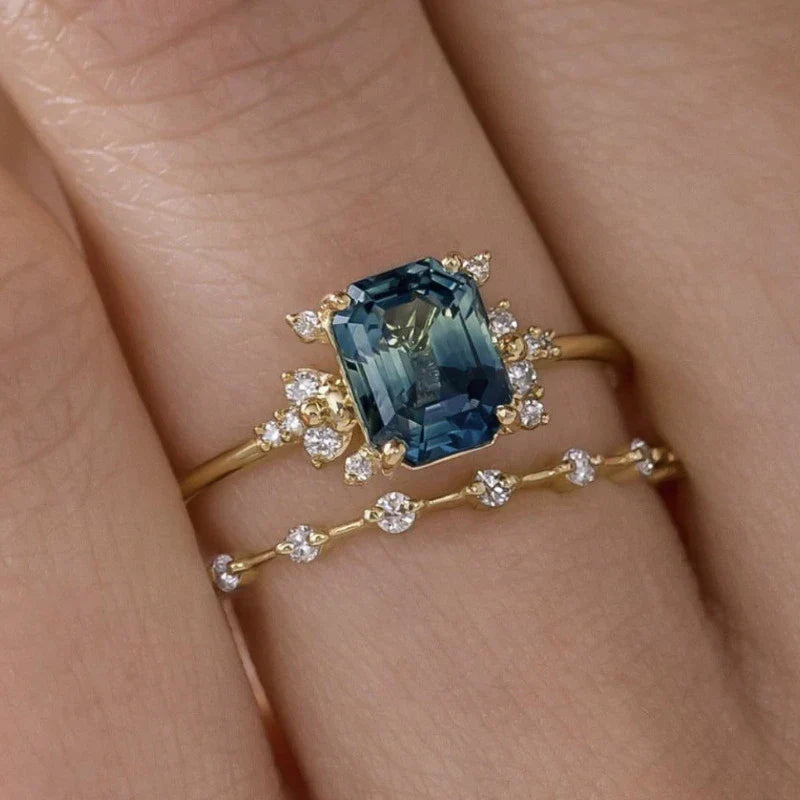 Soft shine ring set in gold with crystal-blue accents