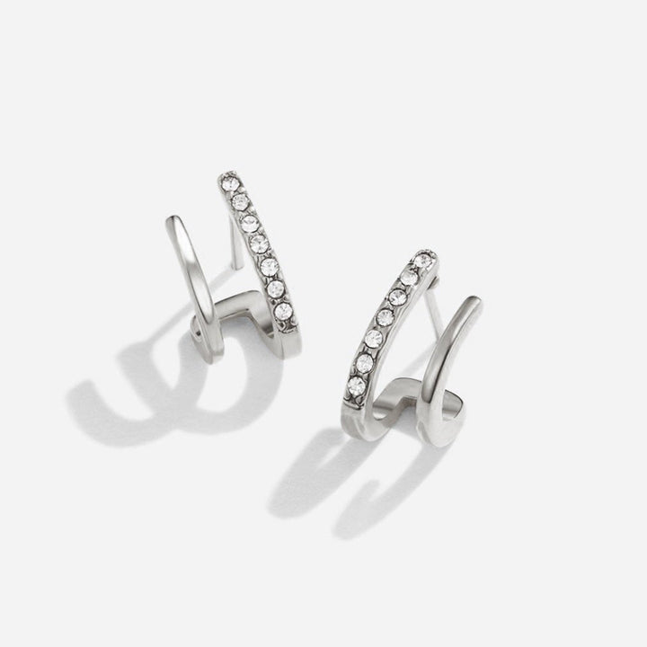 Elegant silver earrings with crystal claw design